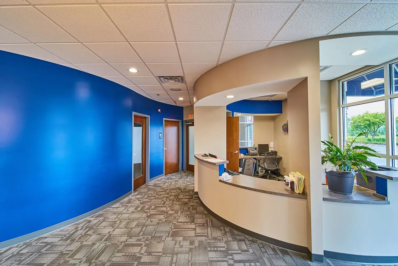 The reception desk and blue feature wall at one of Harrison Dental Group's Fort Wayne offices.